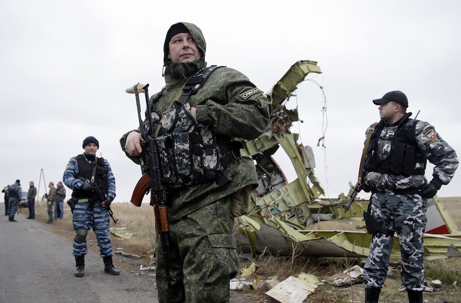 Pro-Russian rebels stand guard at the crash site of Malaysian Airlines jet MH-17 near Donetsk, Ukraine, November 11, 2014