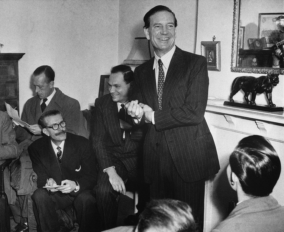 Kim Philby with reporters during the press conference in London, 1955, that cleared him of the charge of tipping off double agents Guy Burgess and Donald Maclean, who had defected to the Soviet Union in 1951