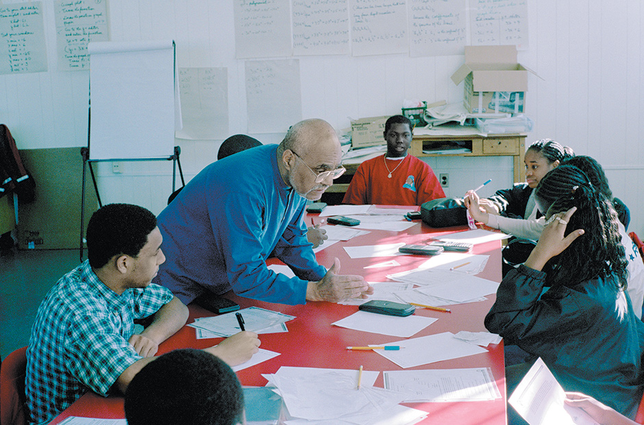 Bob Moses, civil rights activist and founder of the Algebra Project, a program that ‘uses mathematics as an organizing tool to ensure quality public school education for every child in America,’ with students at Lanier High School, Jackson, Mississippi, 2002