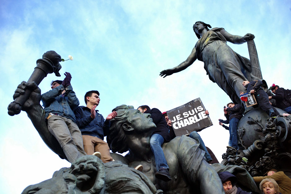 Demonstrators on the Triumph of the Republic statue at Place de la Nation, during the march in support of Charlie Hebdo, Paris, January 11, 2015