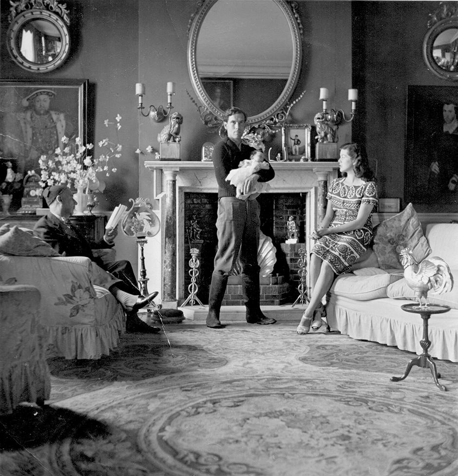 Lord Berners, Robert Heber-Percy with his daughter Victoria, and Jennifer Fry in the drawing room at Faringdon, Berkshire, September 1943; photograph by Cecil Beaton