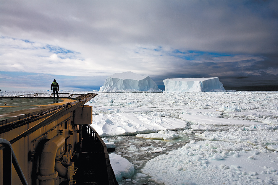 John Palmer, the resident doctor onboard the icebreaker Kapitan Khlebnikov, watching two icebergs about to collide in the Ross Sea off Franklin Island, Antarctica, December 2006; photograph by Camille Seaman from her book Melting Away: A Ten-Year Journey Through Our Endangered Polar Regions, just published by Princeton Architectural Press