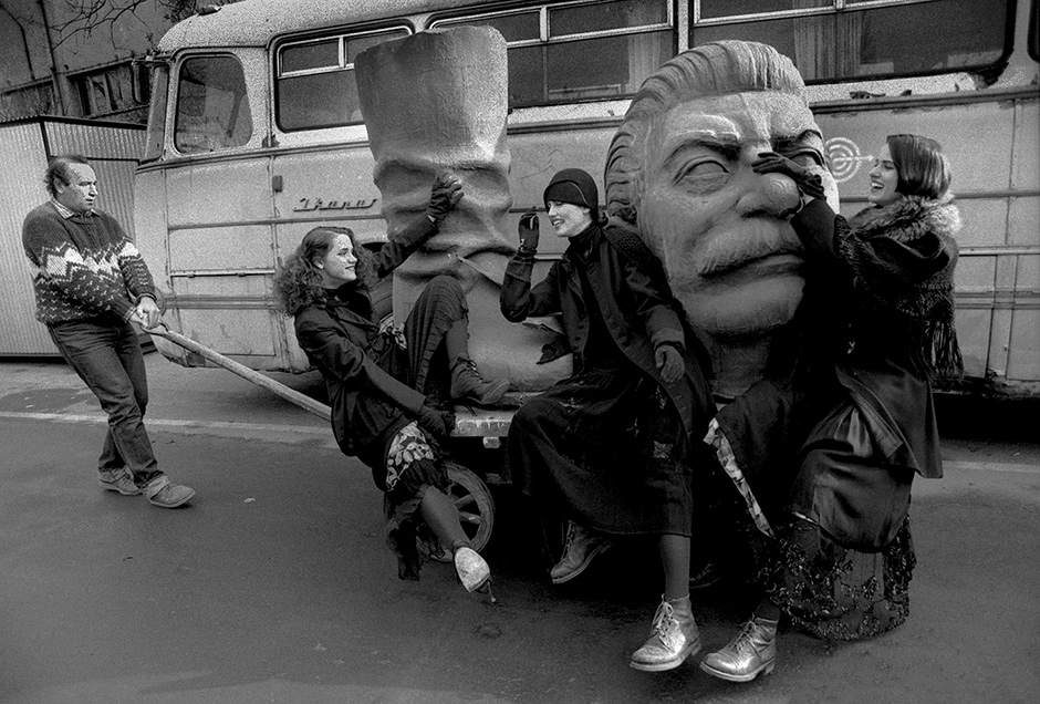 A fashion shoot on a dismantled statue of Stalin, Budapest, 1990