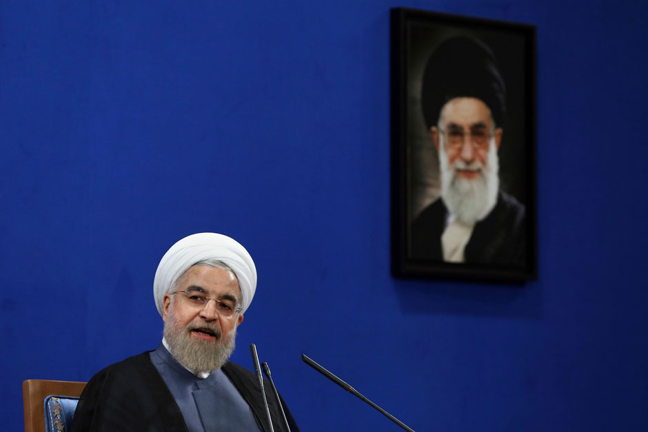 Iranian President Hassan Rouhani, with a picture of Supreme Leader Ali Khamenei, Tehran,  June 13, 2015