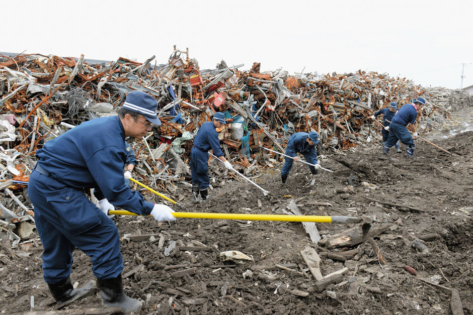 Police searching for victims' remains at the site of Namie Elementary School, Fukushima, Japan, June 11, 2014  