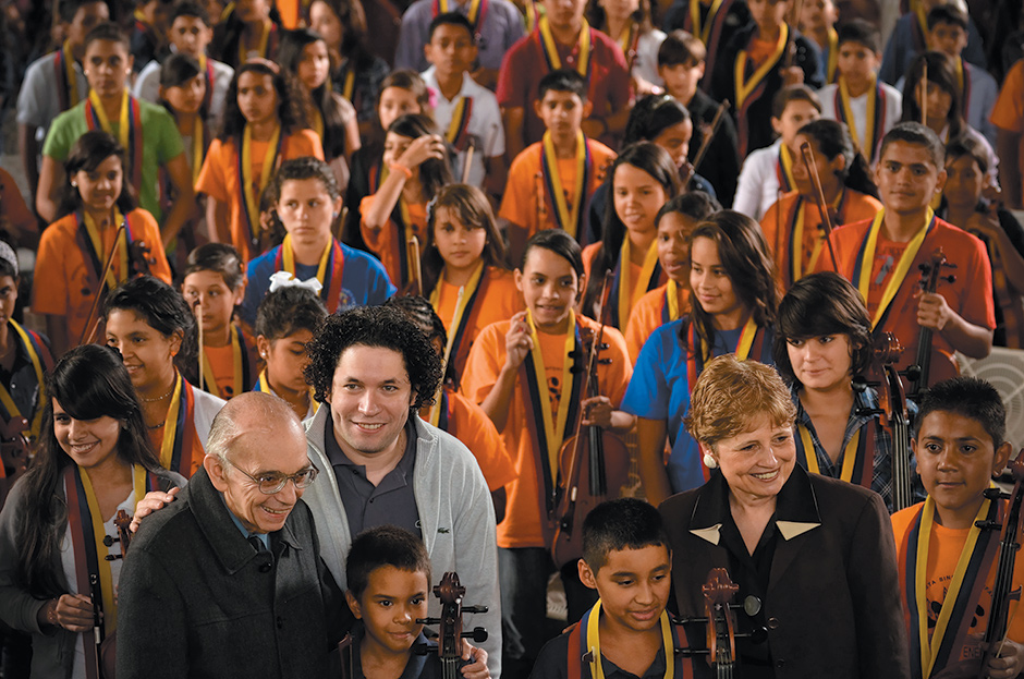 José Antonio Abreu, Gustavo Dudamel, and Deborah Borda of the Los Angeles Philharmonic with an orchestra of children trained by El Sistema, Caracas, Venezuela, February 2012