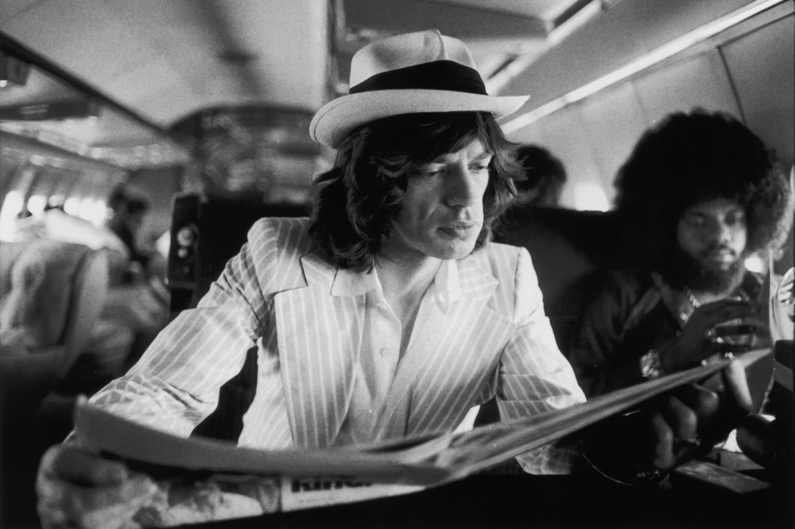 Mick Jagger and keyboardist Billy Preston on board the Rolling Stones’ private jet during their Tour of the Americas, 1975