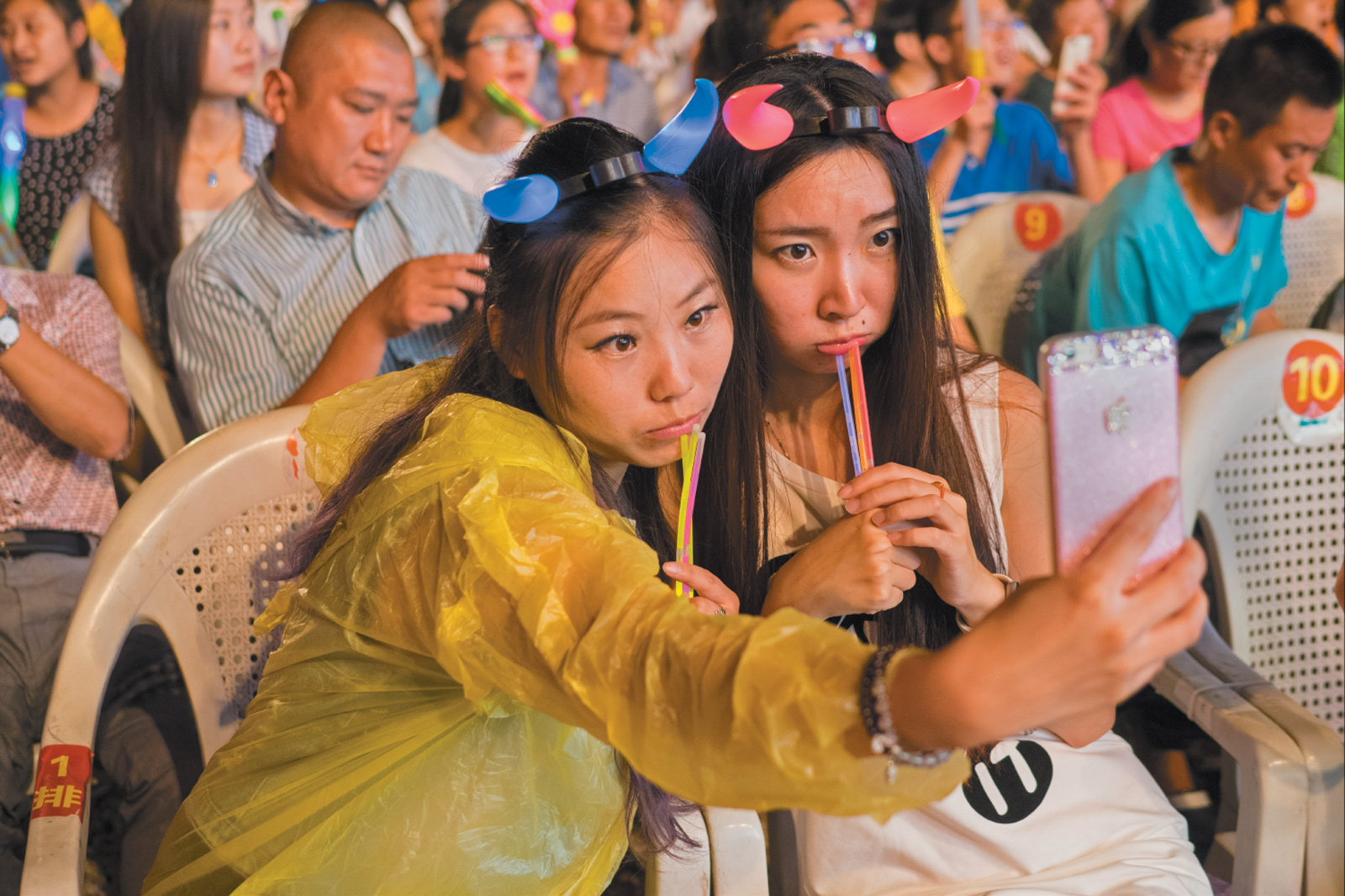 Attendees of the Qingdao International Beer Festival taking a selfie with a smartphone, Shandong province, China, August 2015