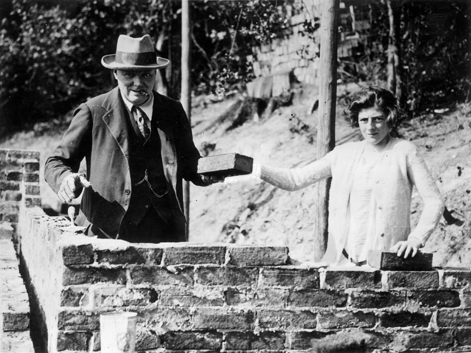 Winston Churchill and his daughter Sarah laying bricks at their house in Chartwell, Kent, September 1928