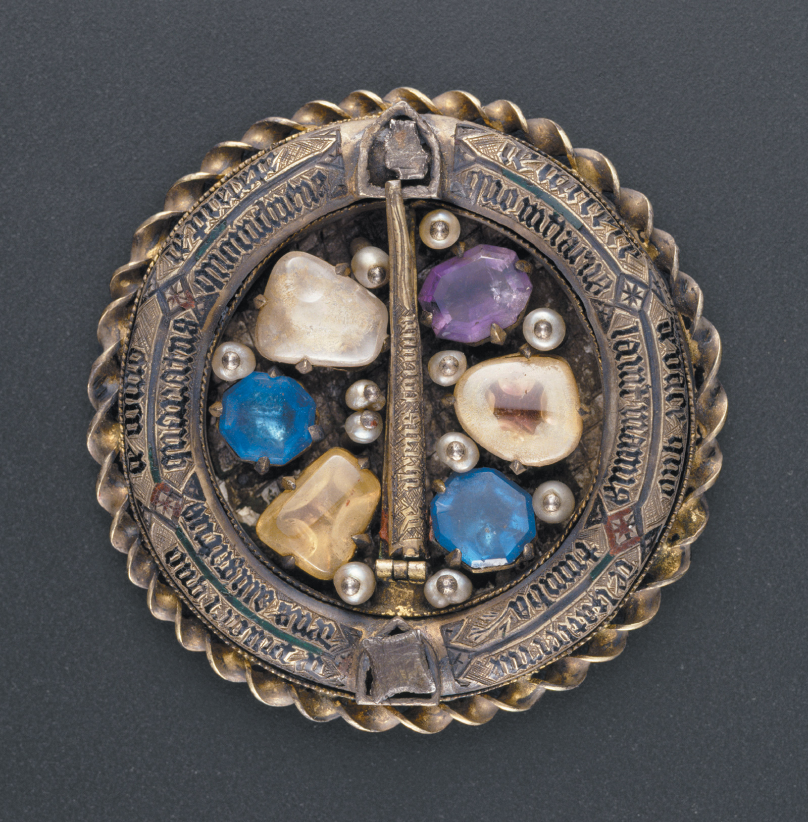 A reliquary medallion from the court of Charles V of France, who reigned from 1364 to 1380. According to Cynthia Hahn in Saints and Sacred Matter, ‘on the front of the object we see what looks like the back of a ring brooch. The thorn [from Christ’s crown of thorns], identified in inscriptions as enclosed in the brooch’s “pin,” is encircled by a tubular ring that also holds Passion relics and reinforces the idea of the Crown.’