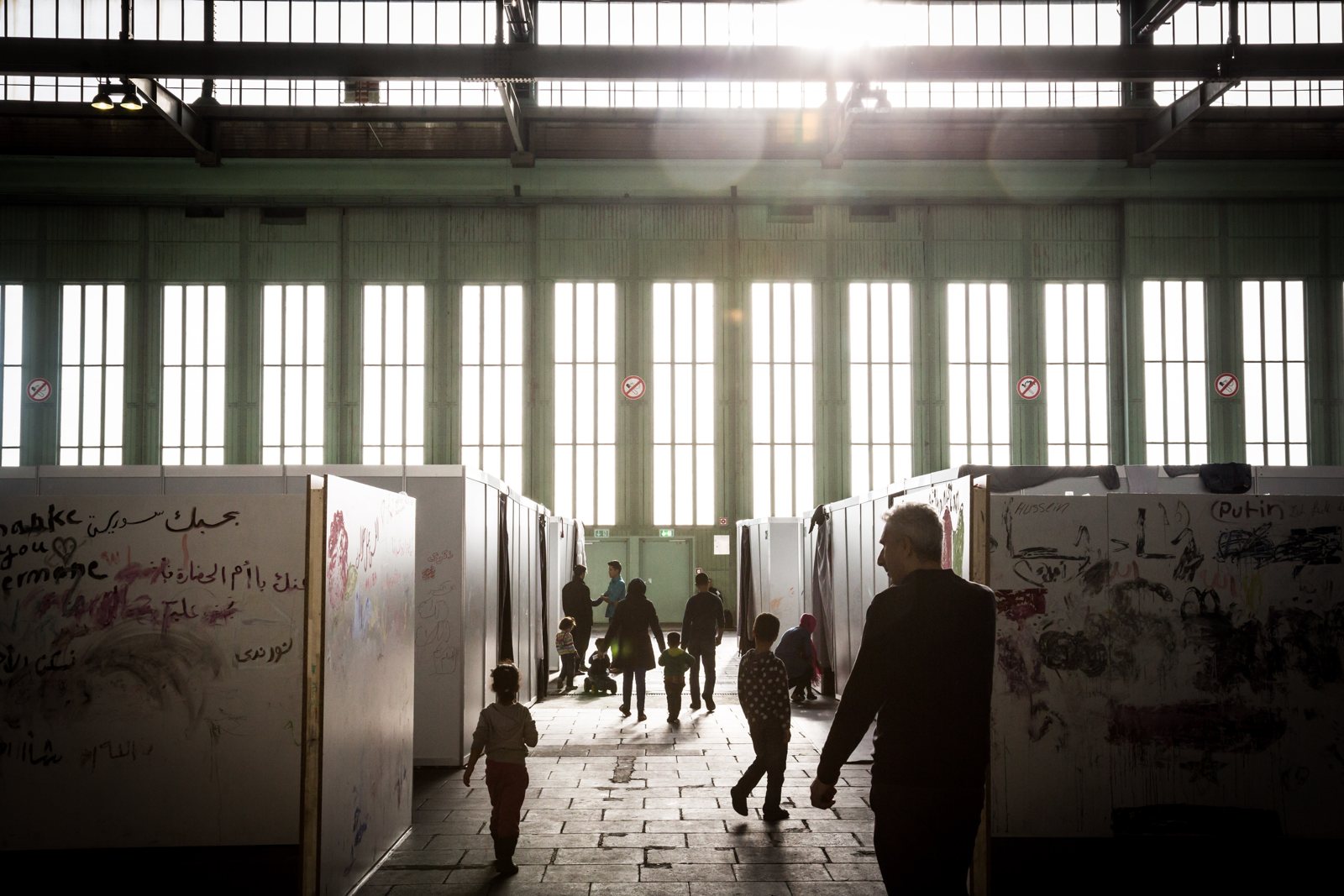 Refugees from Syria, Afghanistan, Iraq, and elsewhere in temporary housing at the former Tempelhof Airport, Berlin, February 2016