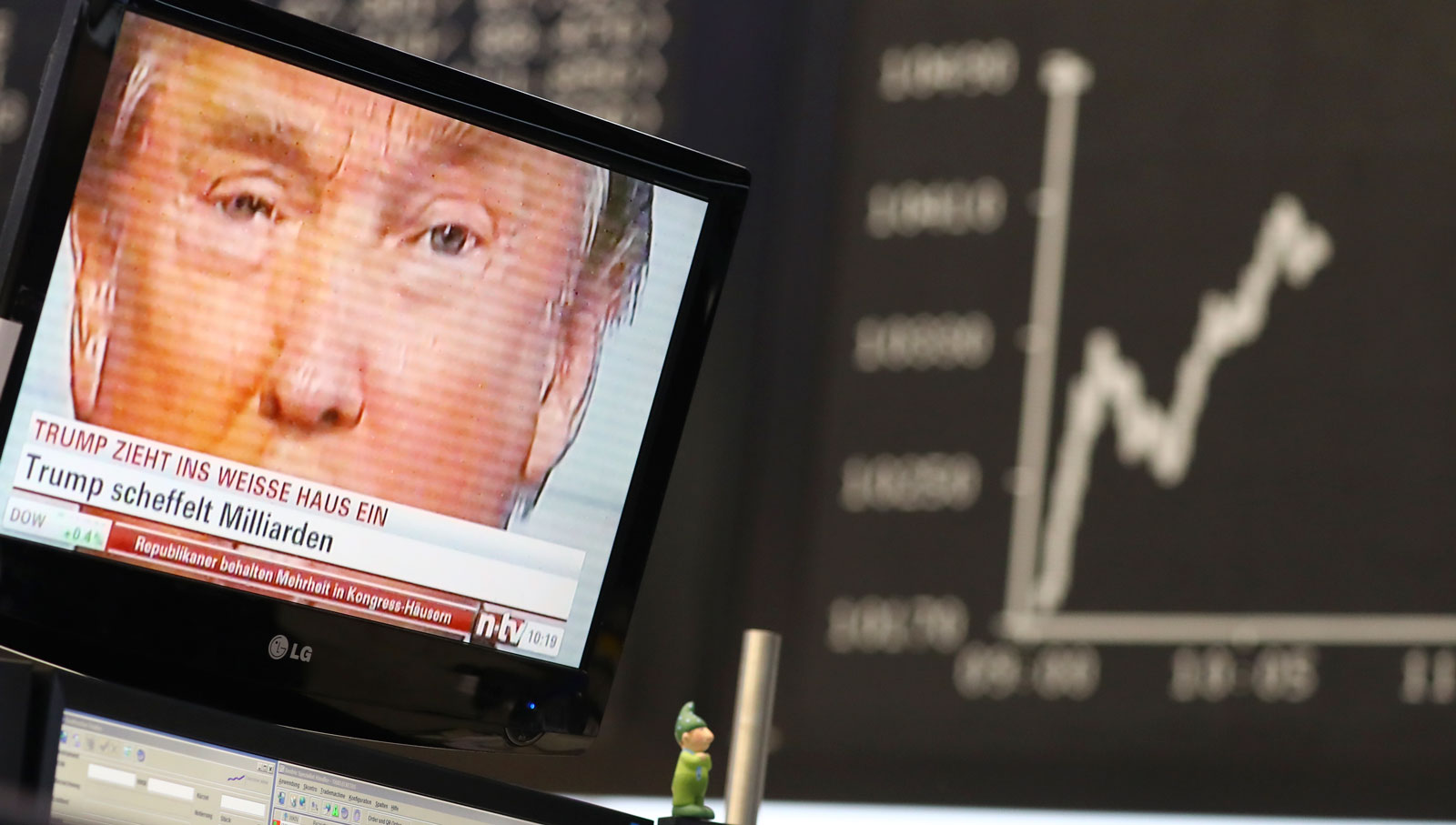 Donald Trump is pictured onscreen in front of the German share price index at the stock exchange in Frankfurt, Germany, November 9, 2016