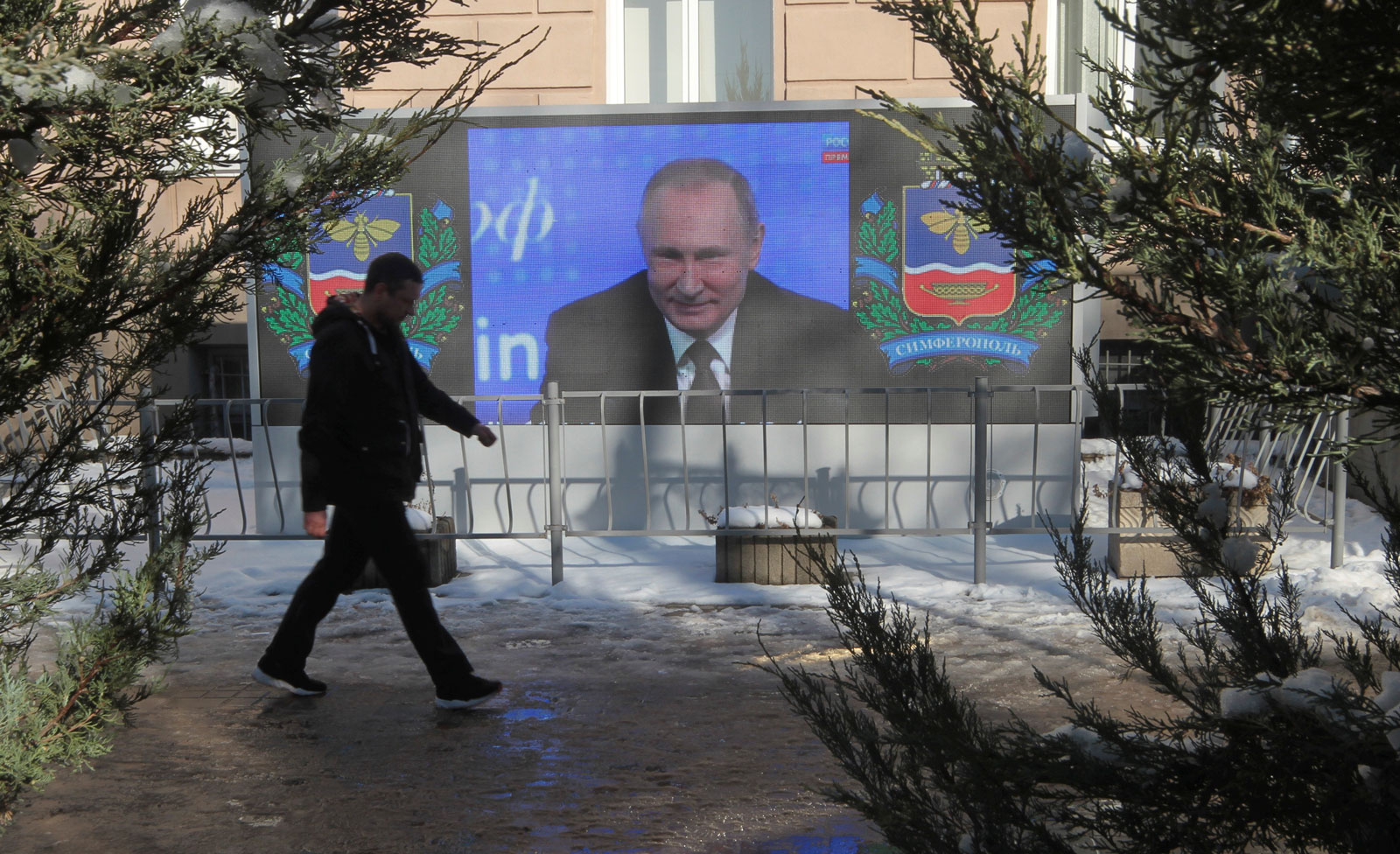 Vladimir Putin on screen delivering an annual news conference, in Simferopol, Crimea, December 23, 2016