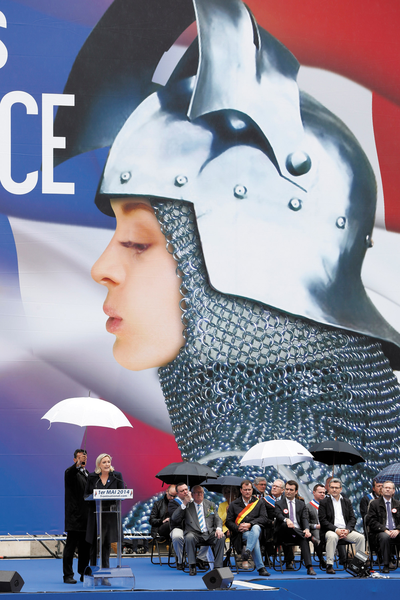 Marine Le Pen delivering a speech in front of a poster of Joan of Arc during the National Front’s May Day rally, Paris, May 2014