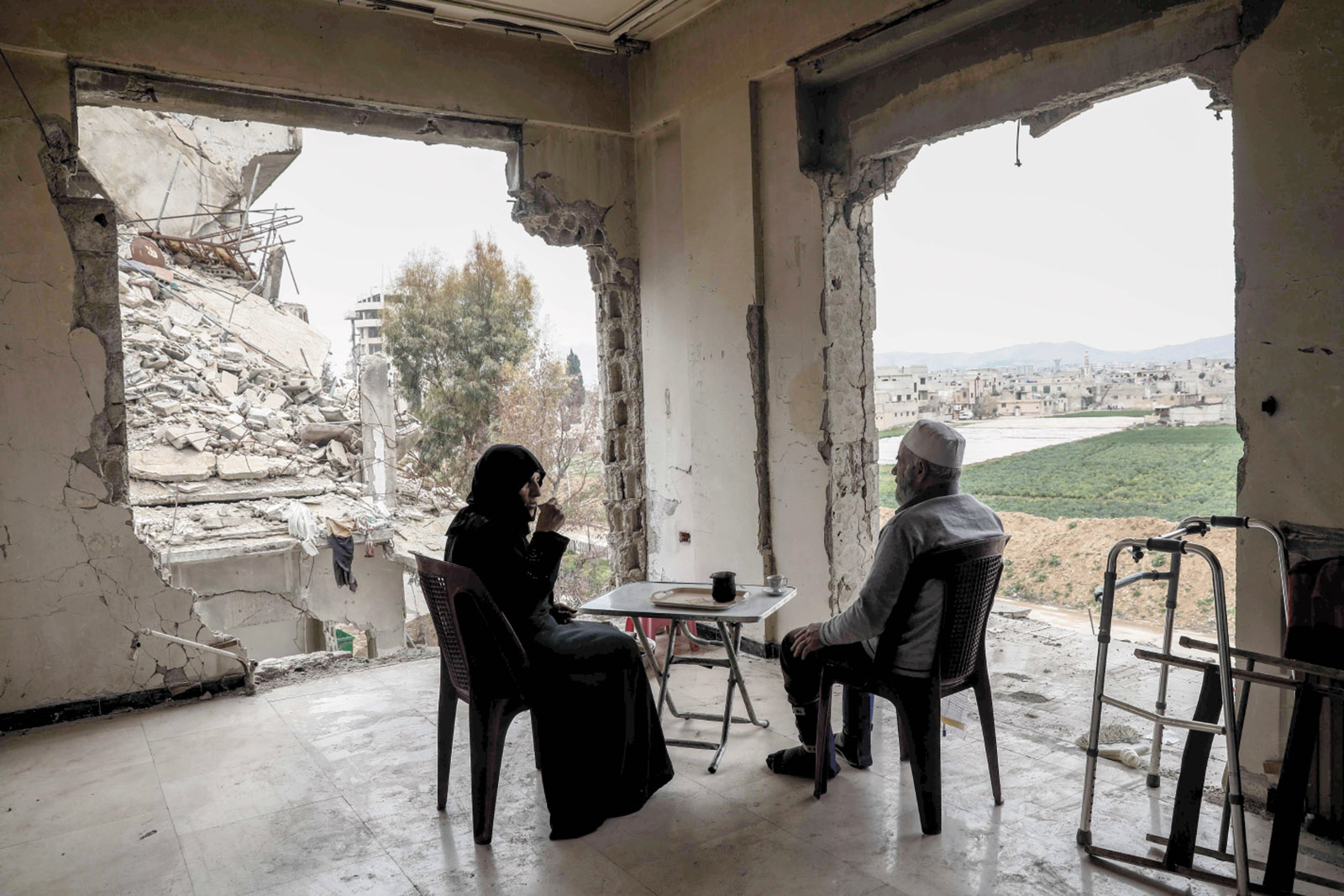 Umm Mohammed and her husband drinking coffee at their destroyed home in the rebel-held town of Douma, on the outskirts of Damascus, March 2017