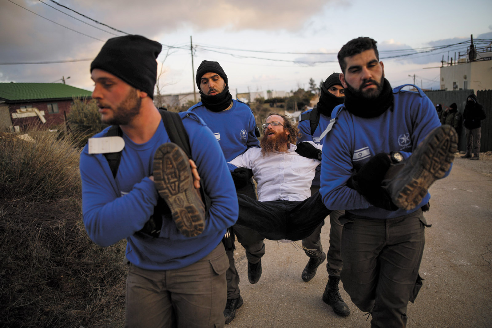 Israeli policemen removing a protester during the eviction of Jewish settlers from the illegal settlement of Amona in the occupied West Bank, February 2017