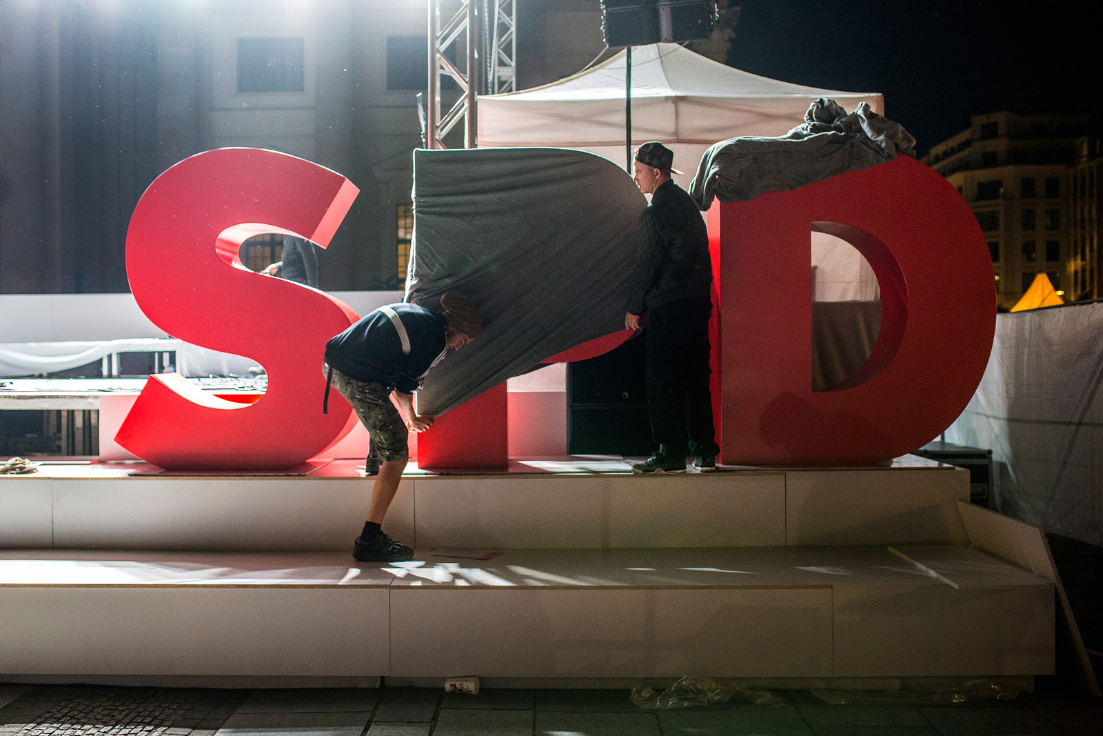 Stage crew members covering the Social Democratic Party of Germany (SPD) logo after a campaign event, Gendarmenmarkt Square, Berlin, September 22, 2017