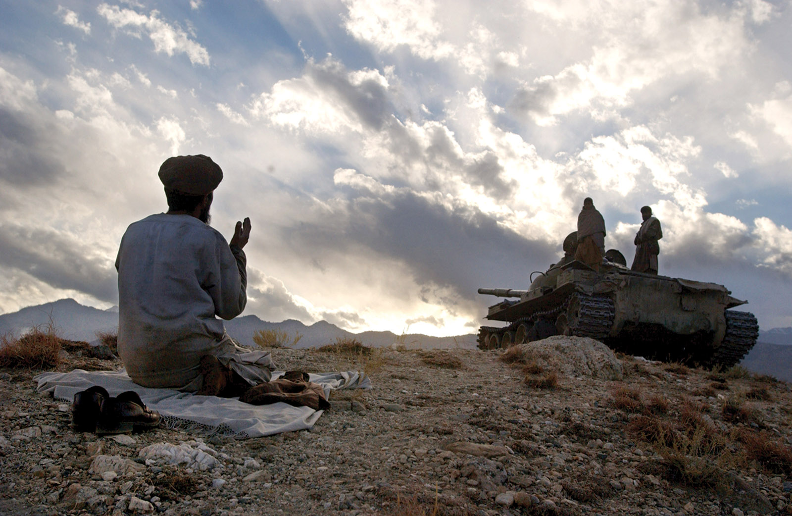 An Afghan soldier praying near Tora Bora during fighting against the Taliban, December 2001