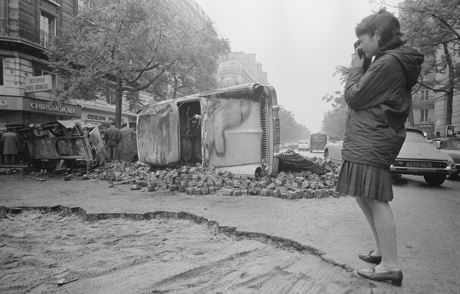 A young Parisian photographing the barricades still in place the morning after riots in May 1968