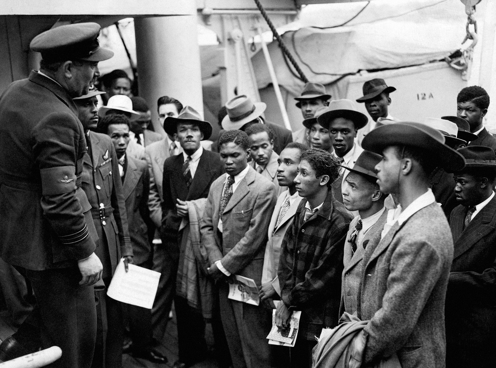 RAF officials from the Colonial Office welcoming Jamaican immigrants disembarked from the Empire Windrush at Tilbury docks, June 22, 1948