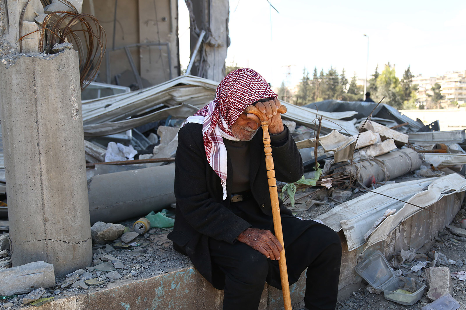 A Syrian man resting amid the rubble of a home in Afrin, March 31, 2018
