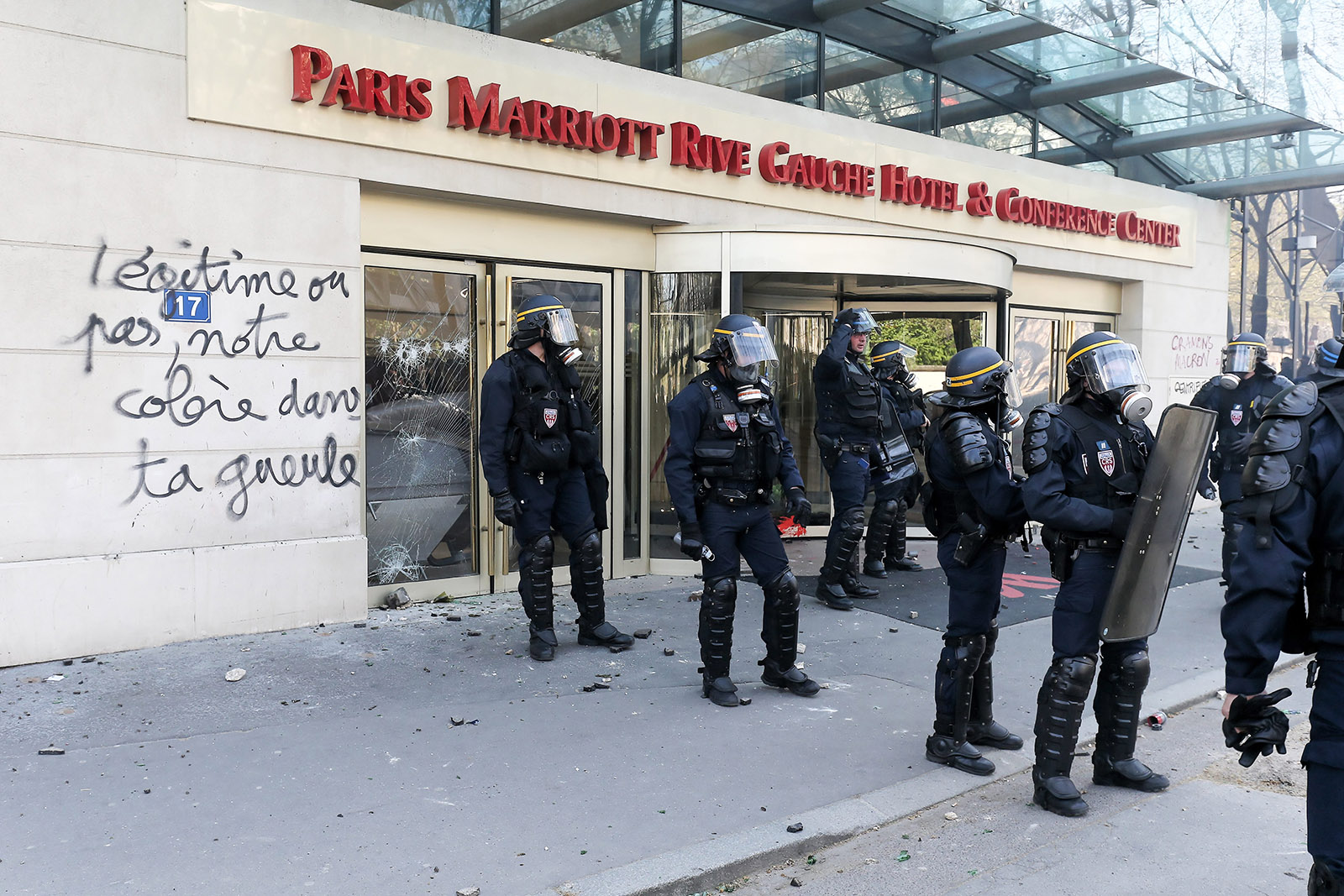 Graffiti reading “legitimate or not, our rage in your face,” as French President Emmanuel Macron prepared to leave for his state visit to the US and riot police in Paris faced violent protests coinciding with a rail strike and student sit-ins, April 19, 2018
