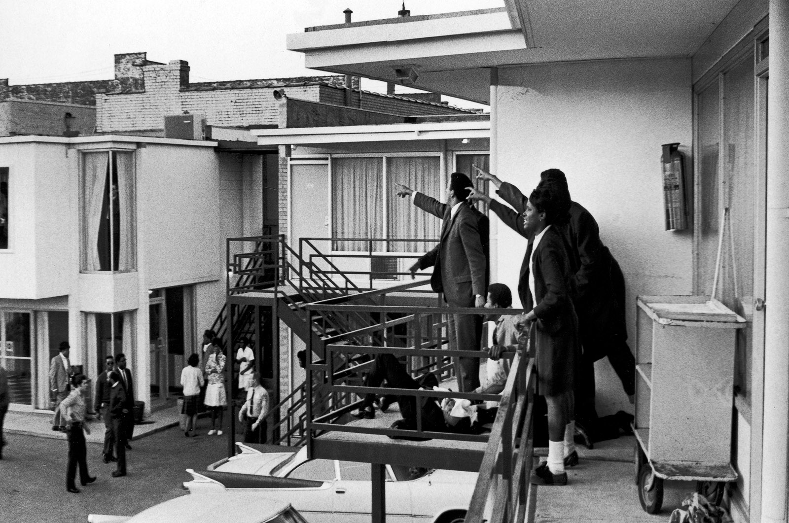 Associates of Dr. Martin Luther King Jr., the slain civil rights leader lying on the motel balcony, pointing in the direction of the assassin, Memphis, Tennessee, April 4, 1968