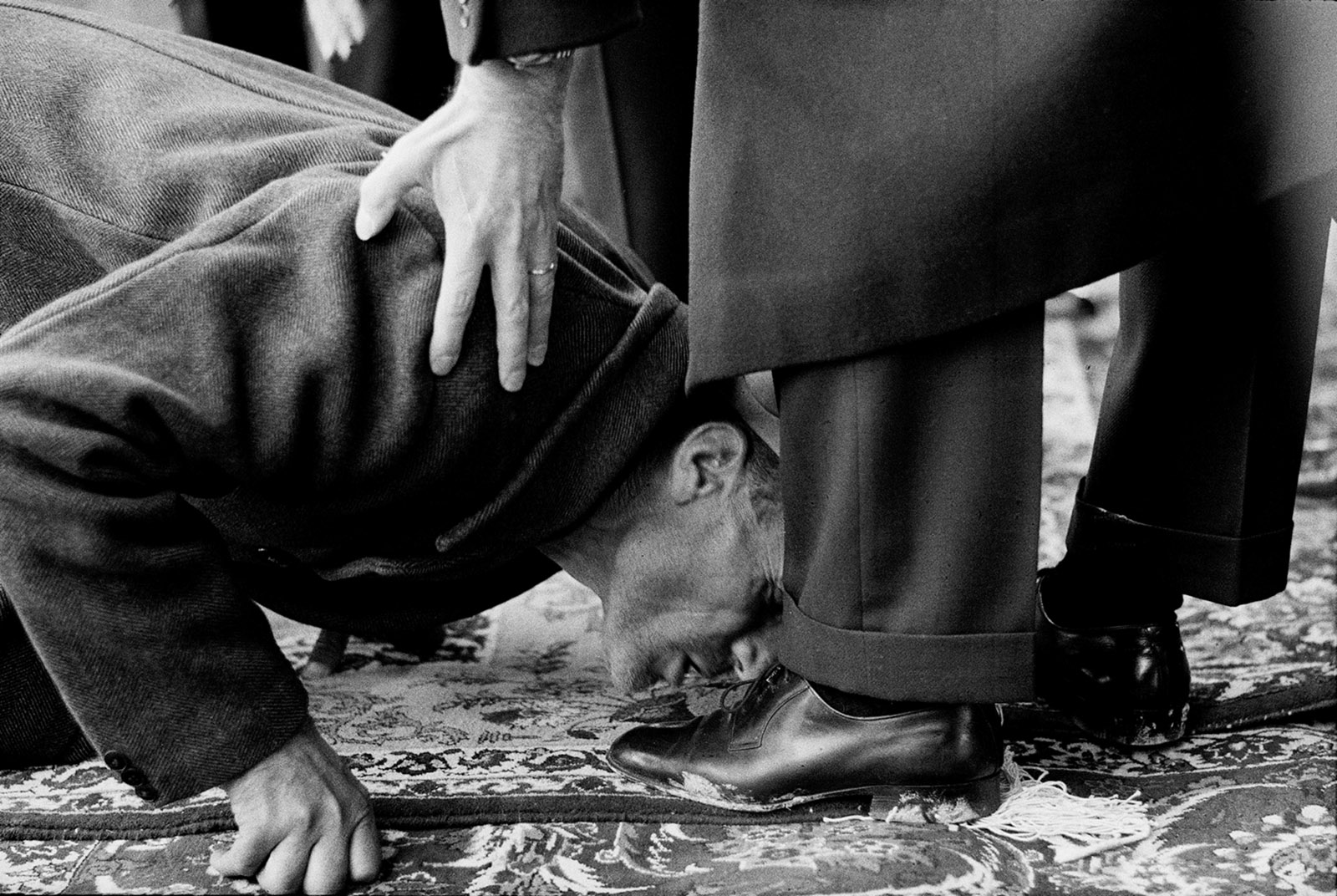 A peasant kissing the feet of Mohammad Reza Shah Pahlavi during a ceremony to distribute land deeds, Isfahan, 1962