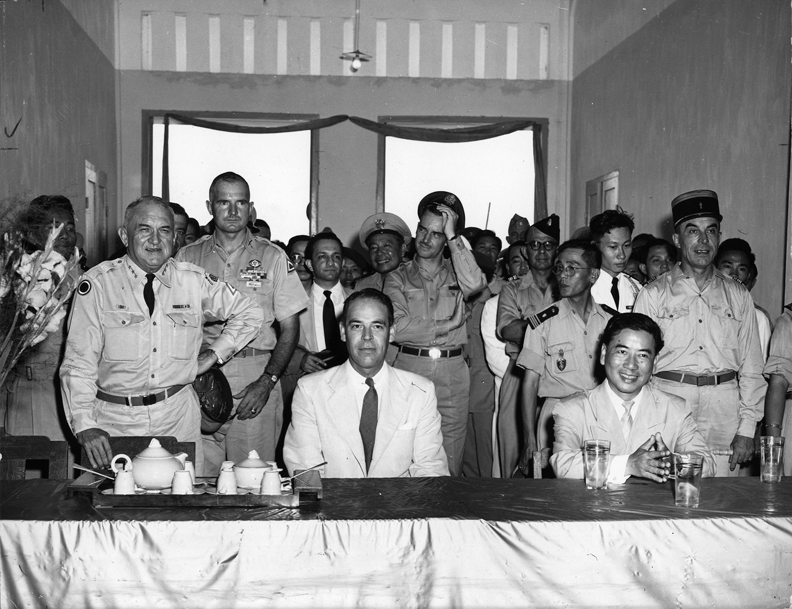 Edward Lansdale (second row, hand on hat) standing behind Lieutenant General John W. ‘Iron Mike’ O’Daniel, commander of the US Military Assistance Advisory Group (left), Ambassador G. Frederick Reinhardt (center), and Ngo Dinh Diem (right), Saigon, 1955