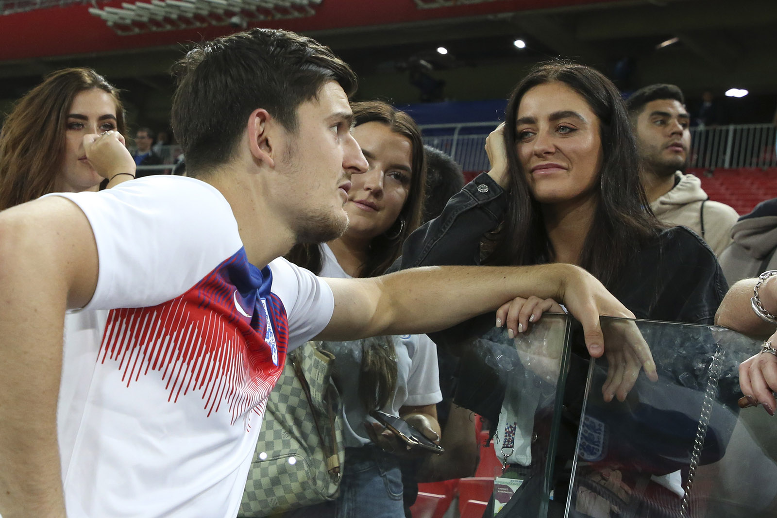 England player Harry Maguire talking to his fiancée Fern Hawkins after the game against Colombia at Spartak Stadium, Moscow, Russia, July 3, 2018