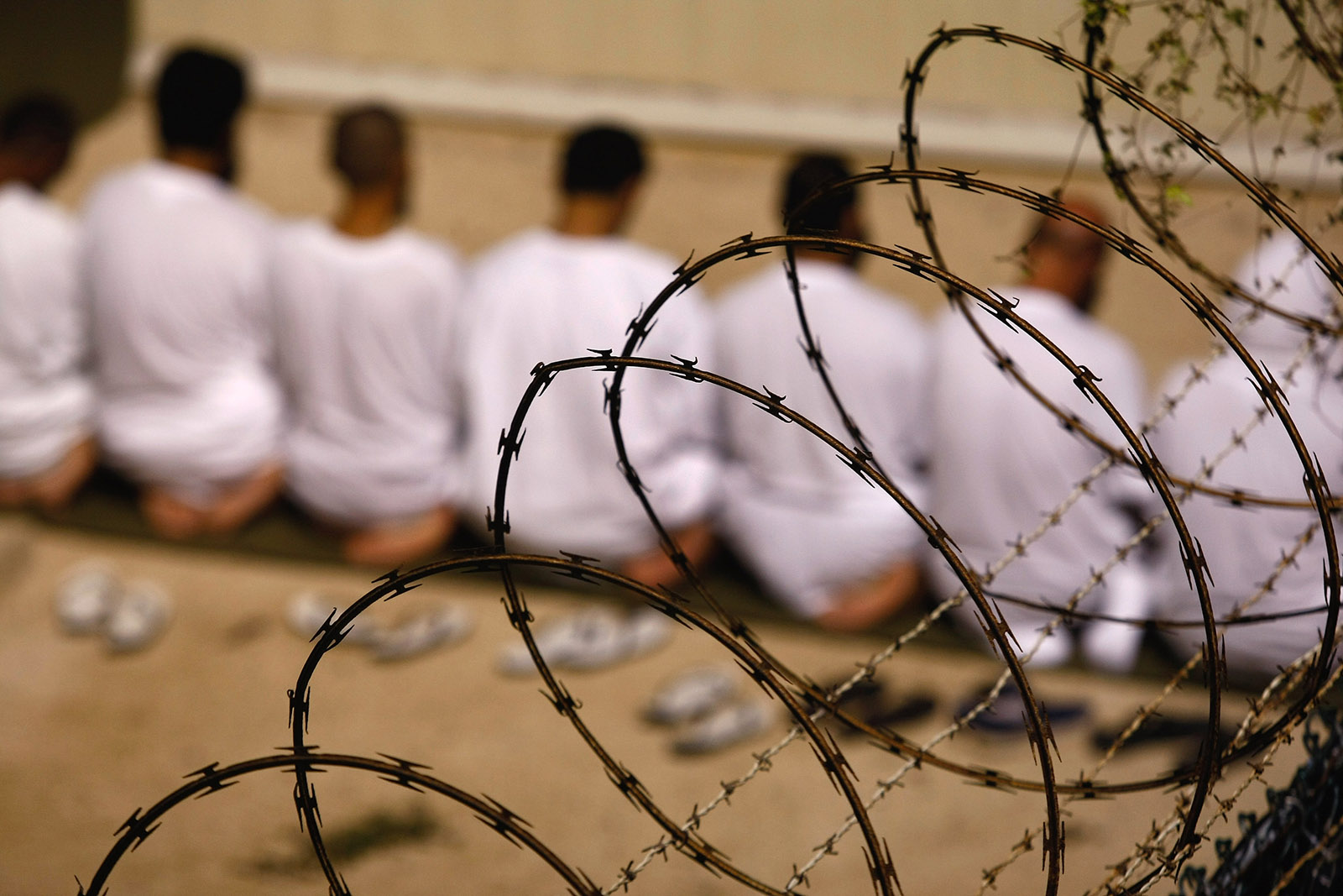A group of detainees kneeling in prayer in the US prison camp at Guantánamo Bay, Cuba, October 28, 2009