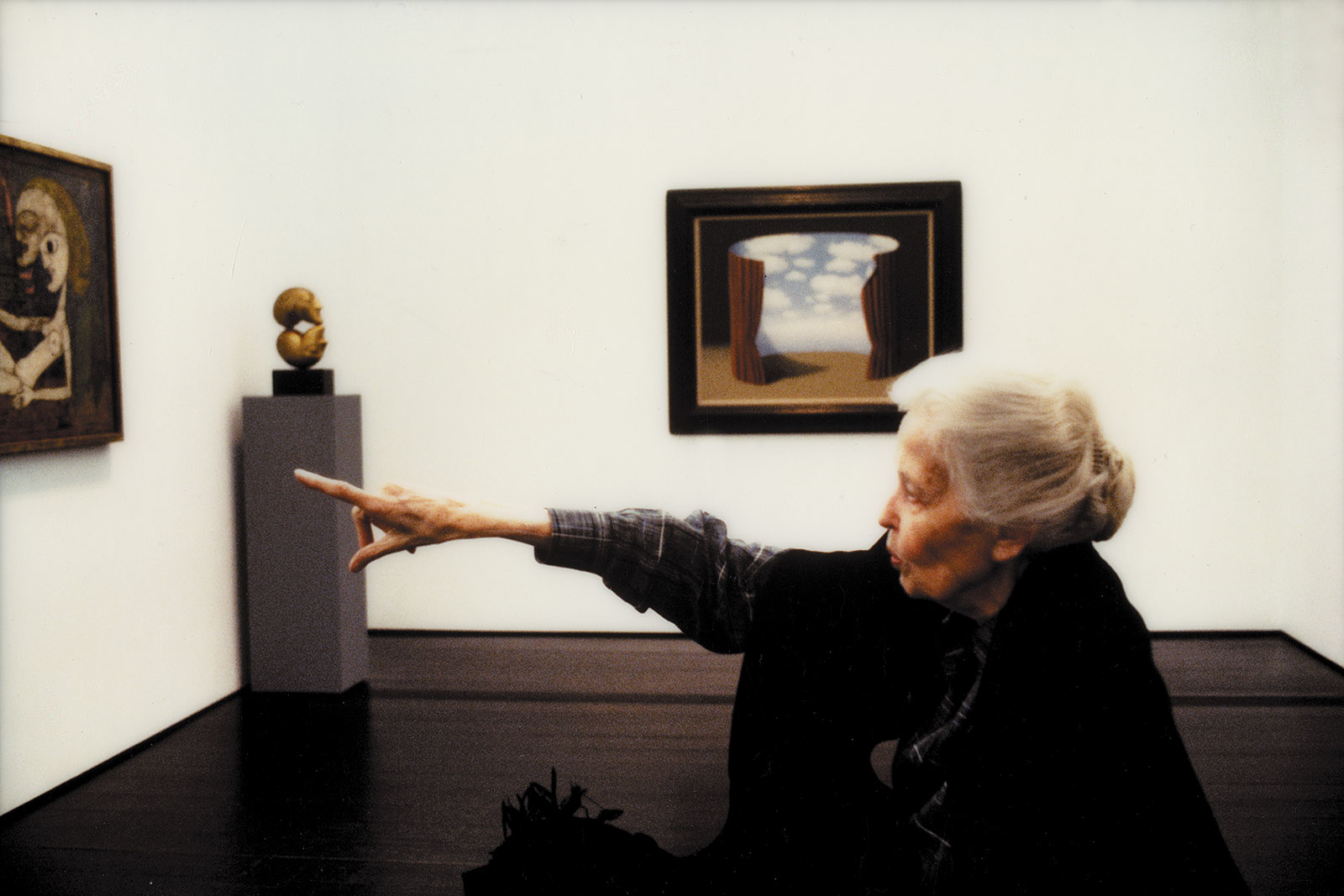Dominique de Menil with artwork by Magritte and others, at the Menil Collection, Houston, 1990