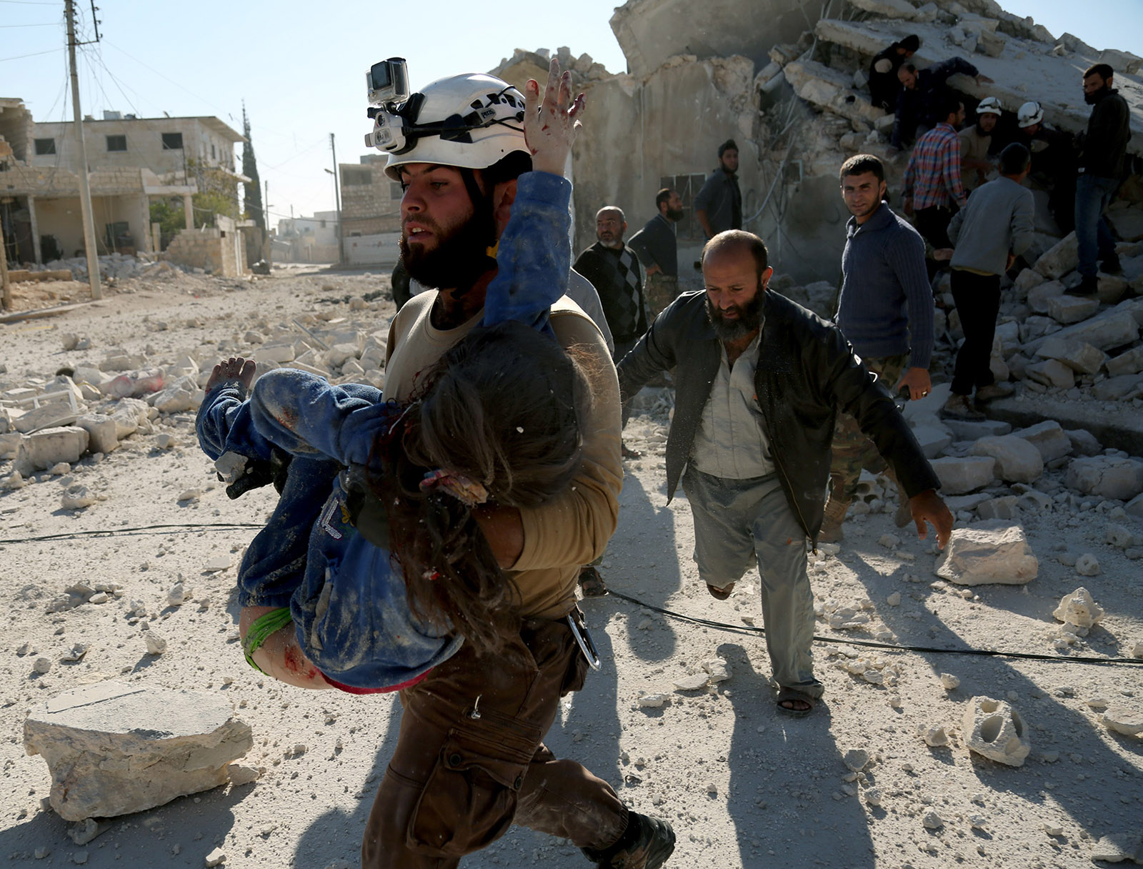 A White Helmet member carrying a wounded girl after Russian airstrikes on Urum al-Kubra, a town west of Aleppo, Syria, November 6, 2016