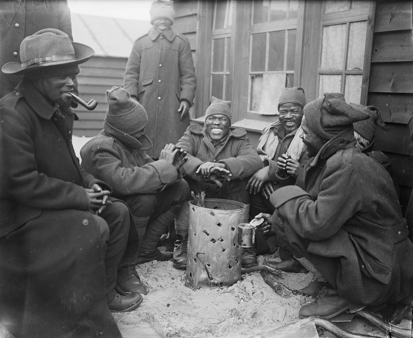 South African Native Labour Corps troops around a brazier at their camp in Dannes, France, March 1917