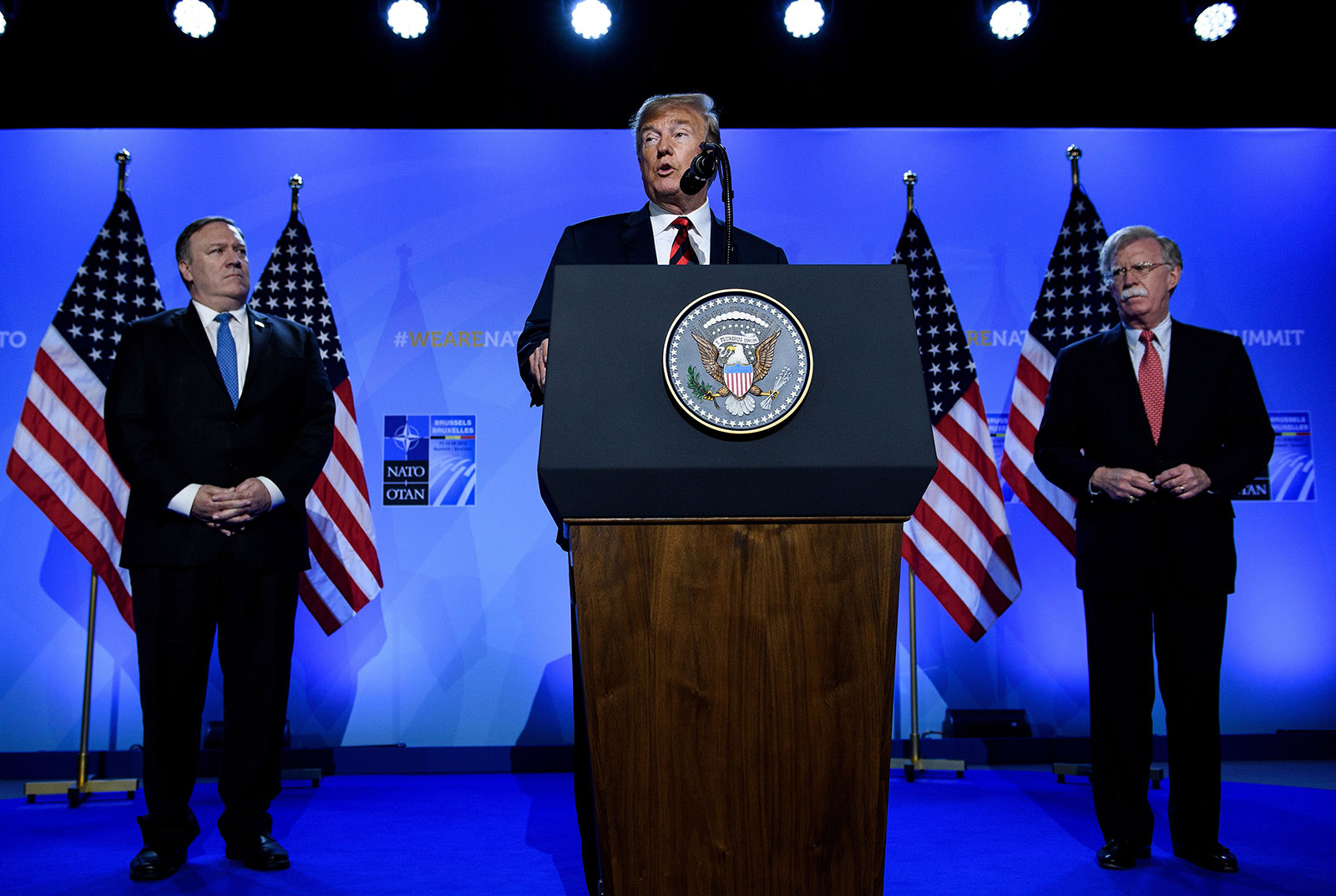 President Trump, flanked by Secretary of State Mike Pompeo and National Security Adviser John Bolton, addressing a press conference at a NATO summit, Brussels, Belgium, July 12, 2018