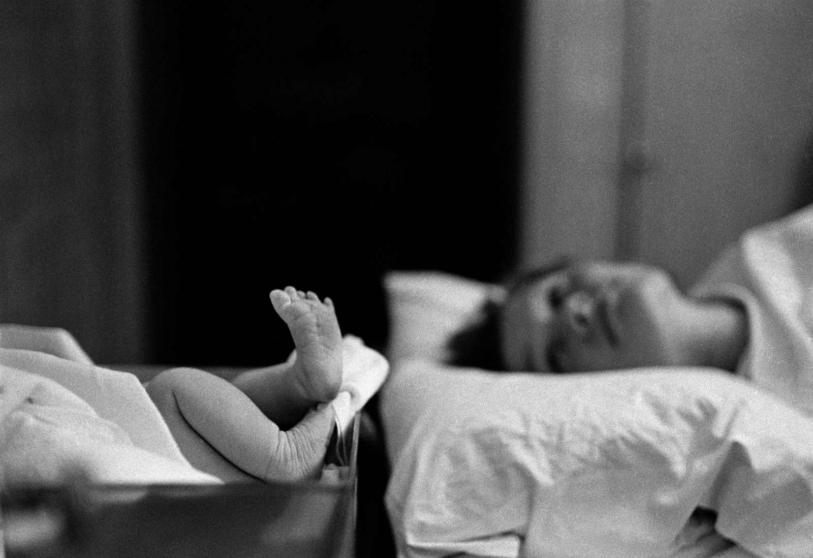 A mother looking at her newborn baby, Long Island, New York, 1959