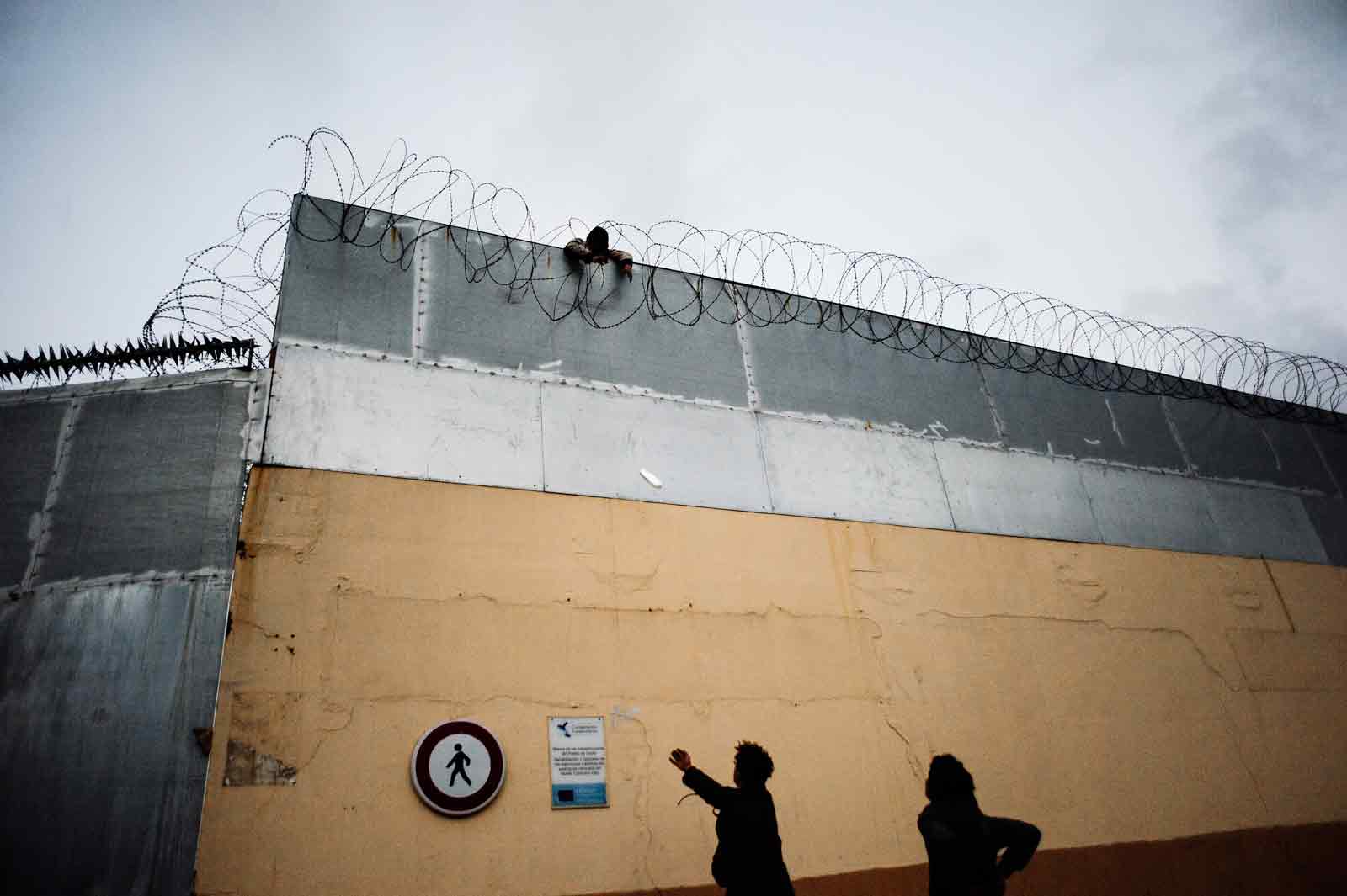 Moroccan minors who have managed to enter the Port of Ceuta and are waiting to attempt to board the ferries to Spain are thrown food by friends on the other side of the port's walls, Ceuta, February 20, 2019 