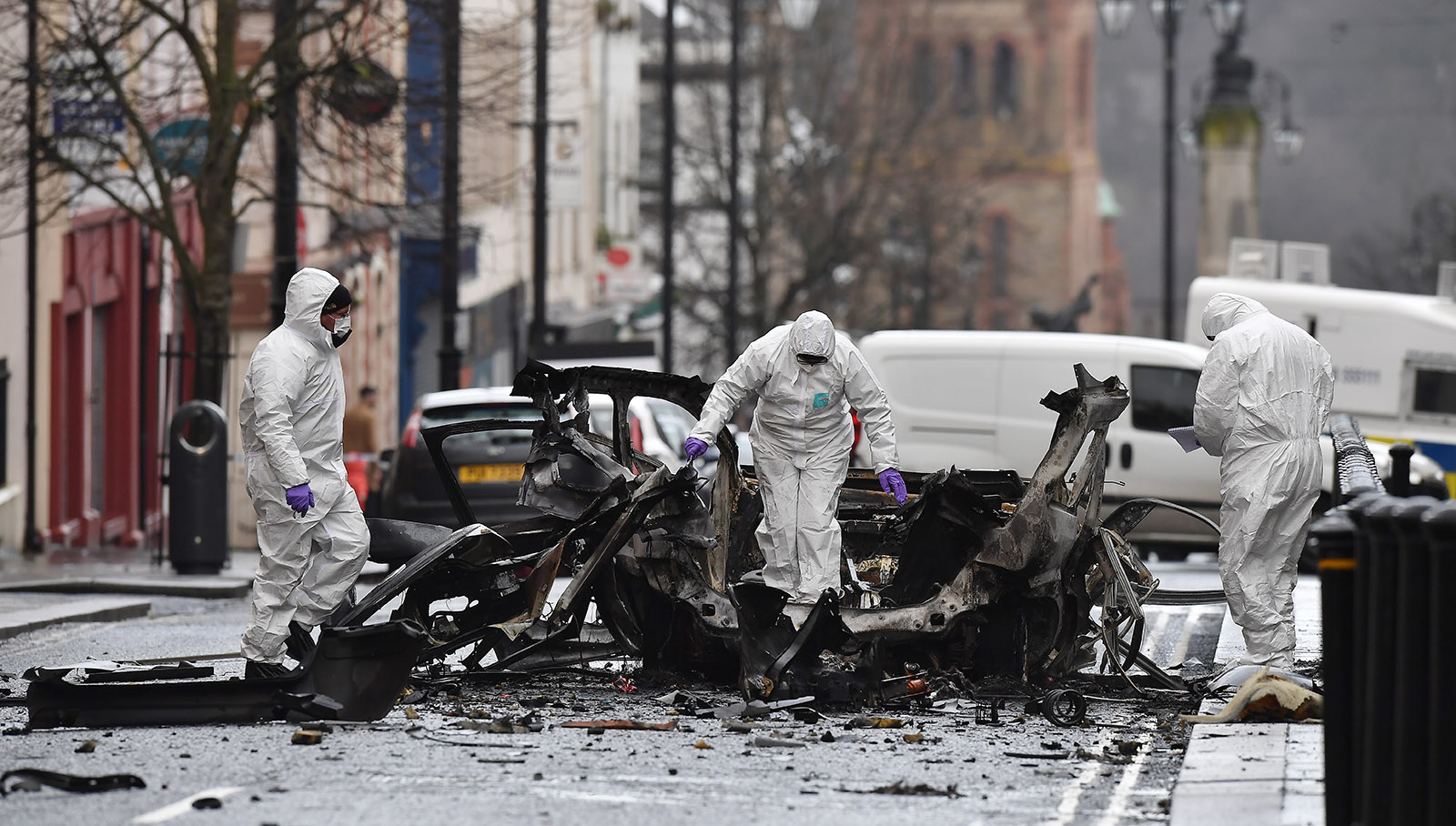 Forensic officers inspecting the remains of a van used as a car bomb in an attack by dissident Republicans outside Derry Court House, Northern Ireland, January 20, 2019