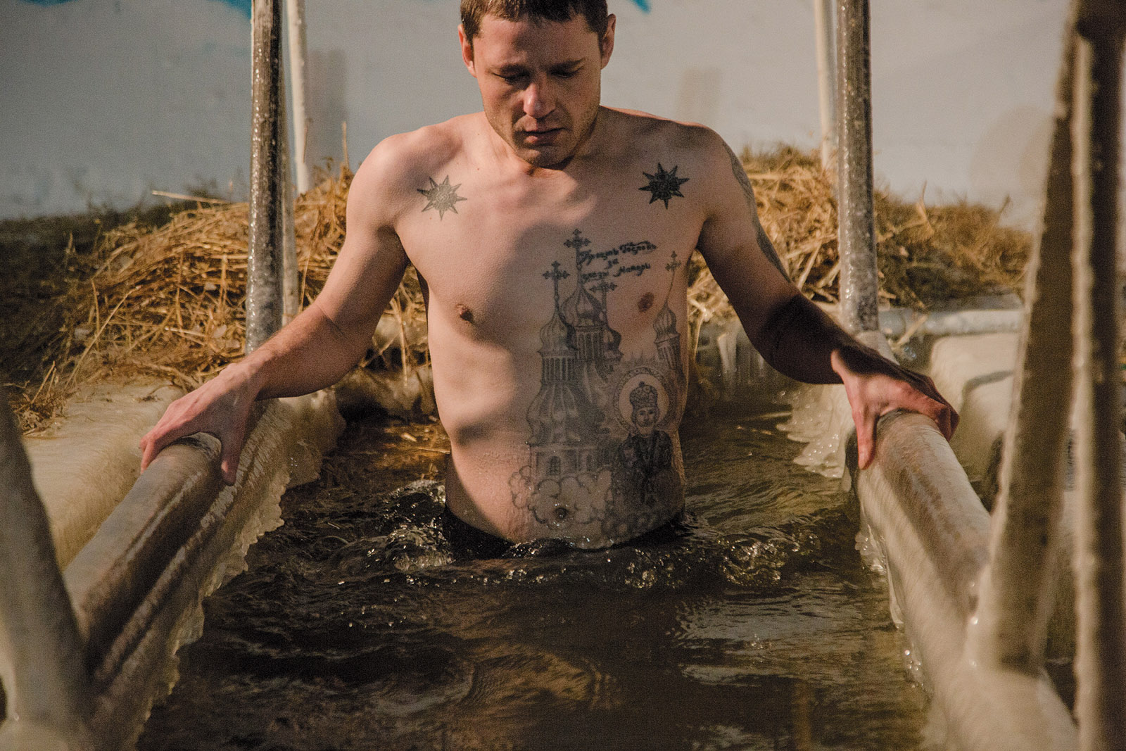 A man with tattoos bathing in the Irtysh River