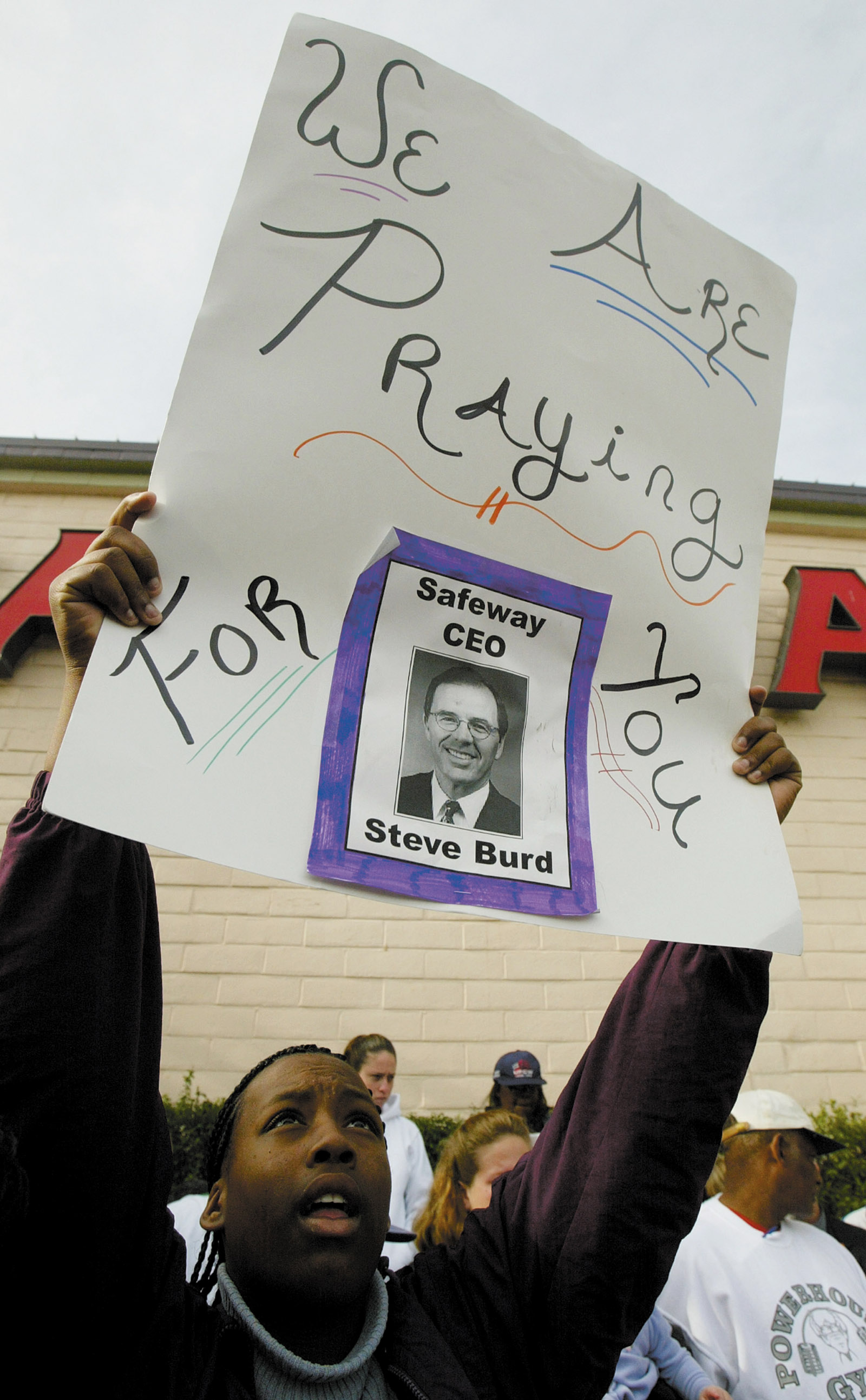 Supporter of striking grocery workers holds a sign, Alamo, California, January 2004