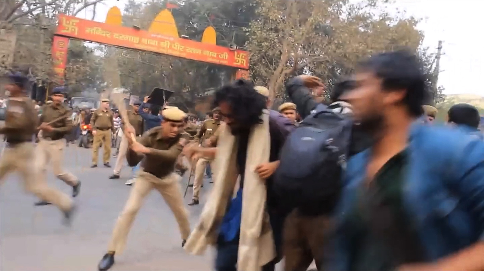 A still from Vivek showing police beating students who were protesting in front of the RSS headquarters in Delhi following the induced suicide of the scholar Rohith Vemula