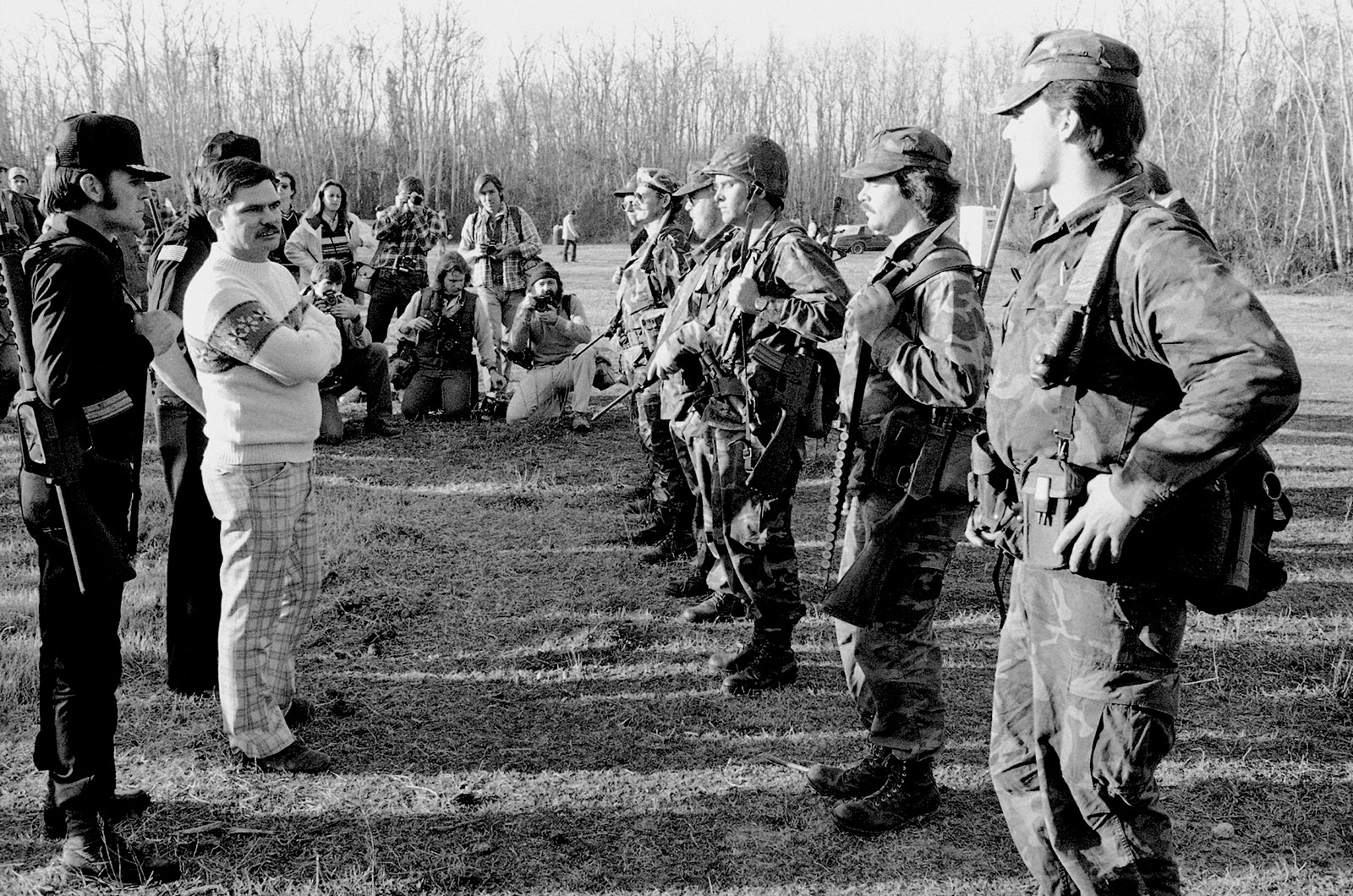 Louis Beam, the Grand Dragon of the Texas Knights of the Ku Klux Klan, inspecting his security forces before a rally against Vietnamese immigrant fishermen along the Gulf Coast, Santa Fe, Texas, 1981