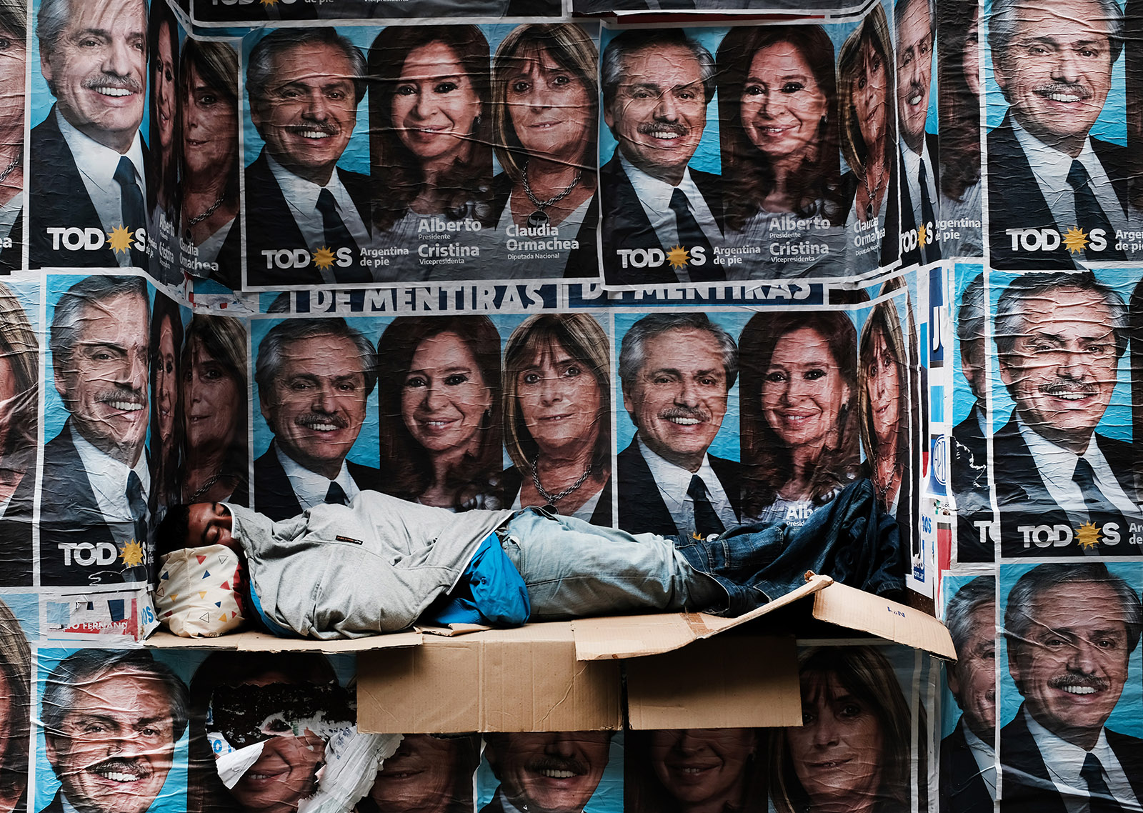 A homeless man sleeping under posters of newly elected President Alberto Fernández and his running mate, Vice-President Cristina Fernández de Kirchner, Buenos Aires, October 28, 2019 