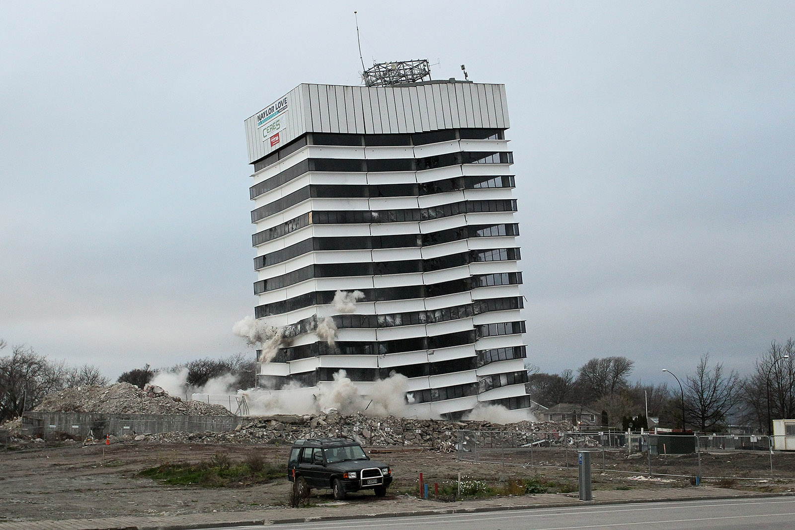 An earthquake-damaged building is demolished by controlled explosions, Christchurch, New Zealand, August 5, 2012
