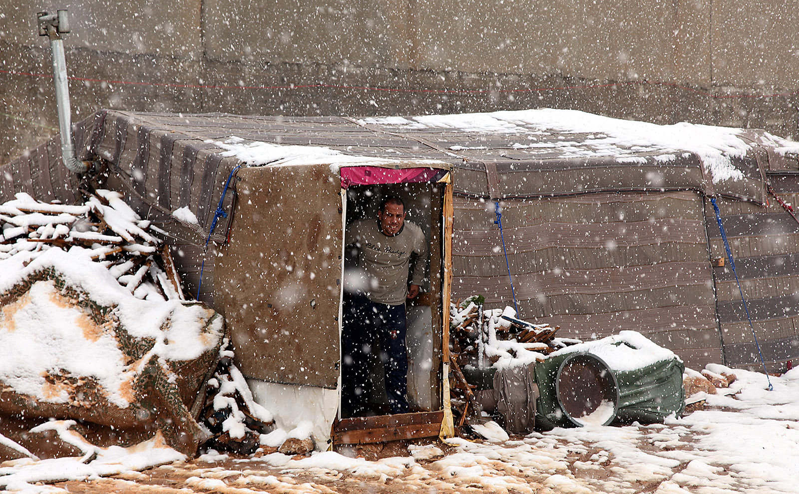 A Syrian refugee looking out of his makeshift tent dwelling in Amman, Jordan, December 12, 2013