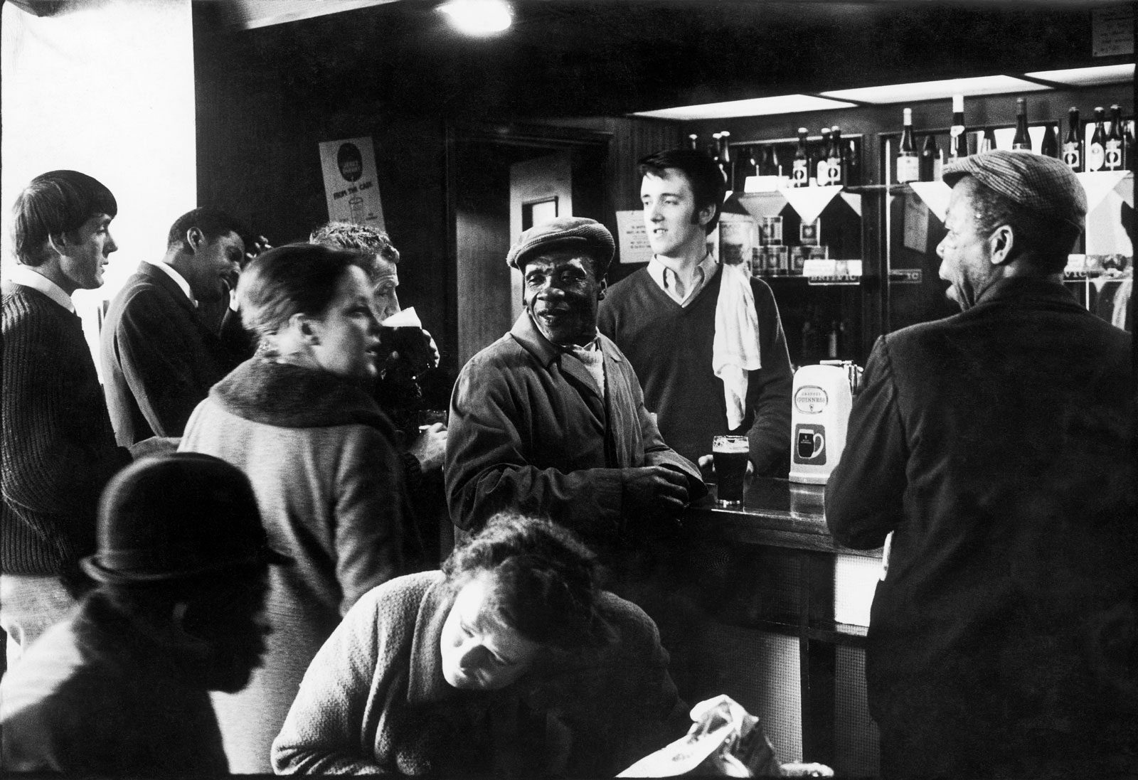 A barman and customers at the Piss House pub on Portobello Road, Notting Hill, London, 1969