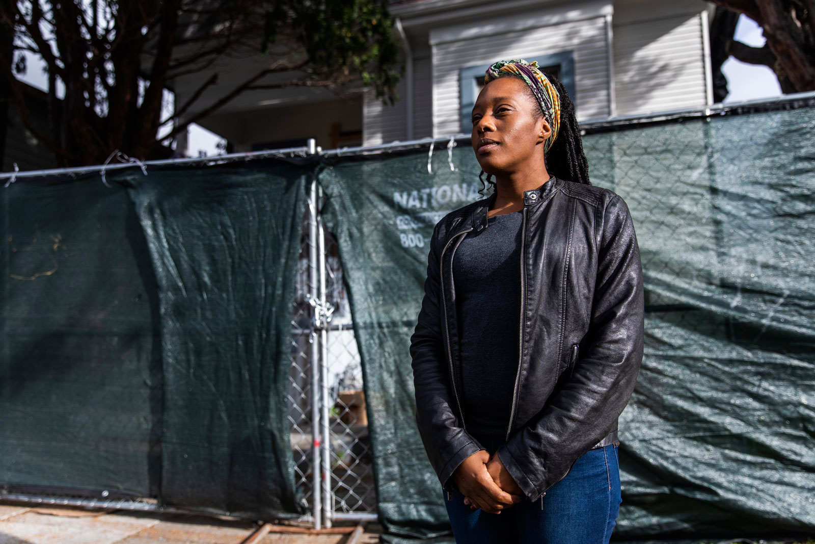 Moms 4 Housing activist Dominique Walker standing in front of 2928 Magnolia Street, the house the group occupied starting in November 2019, declaring that housing is “a human right,