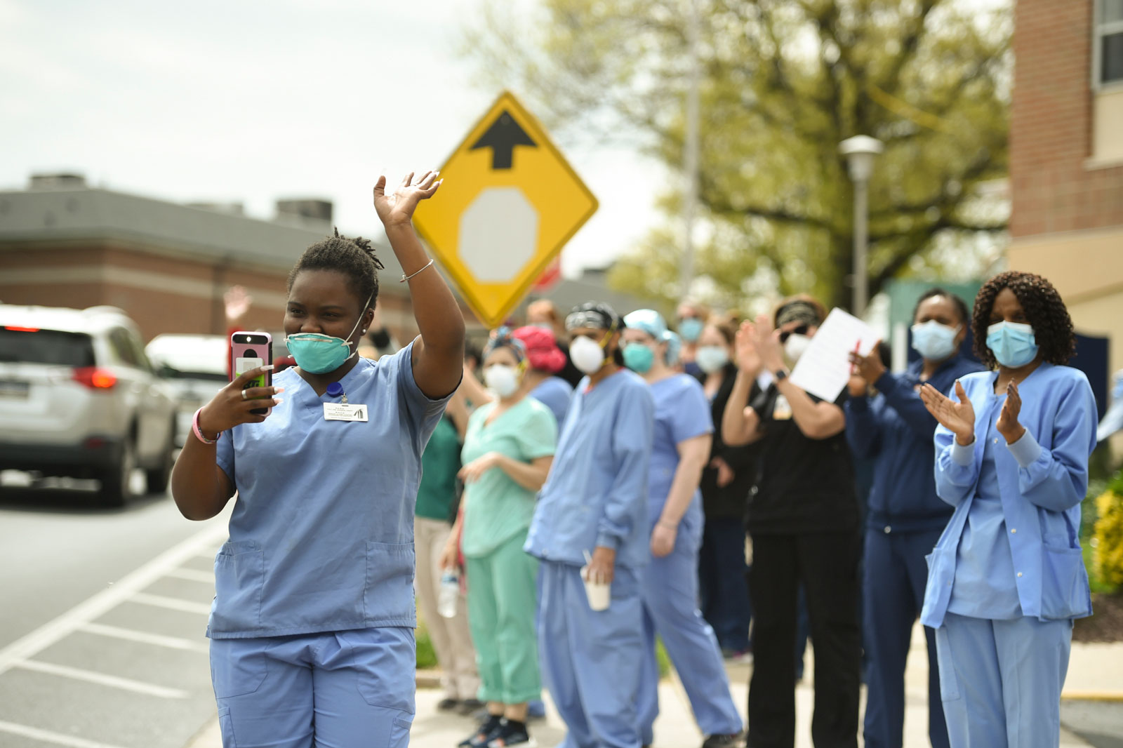 ManorCare workers gathering as people parade past the retirement facility where they work to thank them, West Reading, Pennsylvania, May 5, 2020 