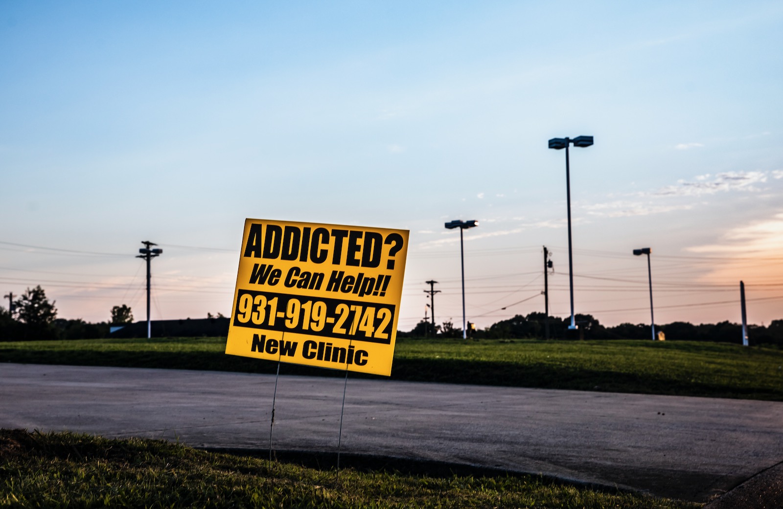 In the field where Dr. Samson Orusa’s clinic used to stand, a sign directing patients to a local Suboxone clinic, Clarksville, Tennessee, July 15, 2020