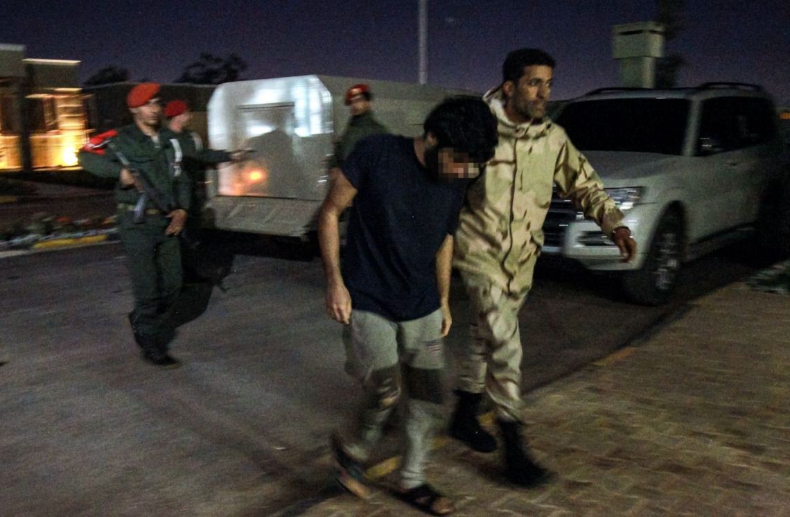 Prisoner escorted by Libyan soldier